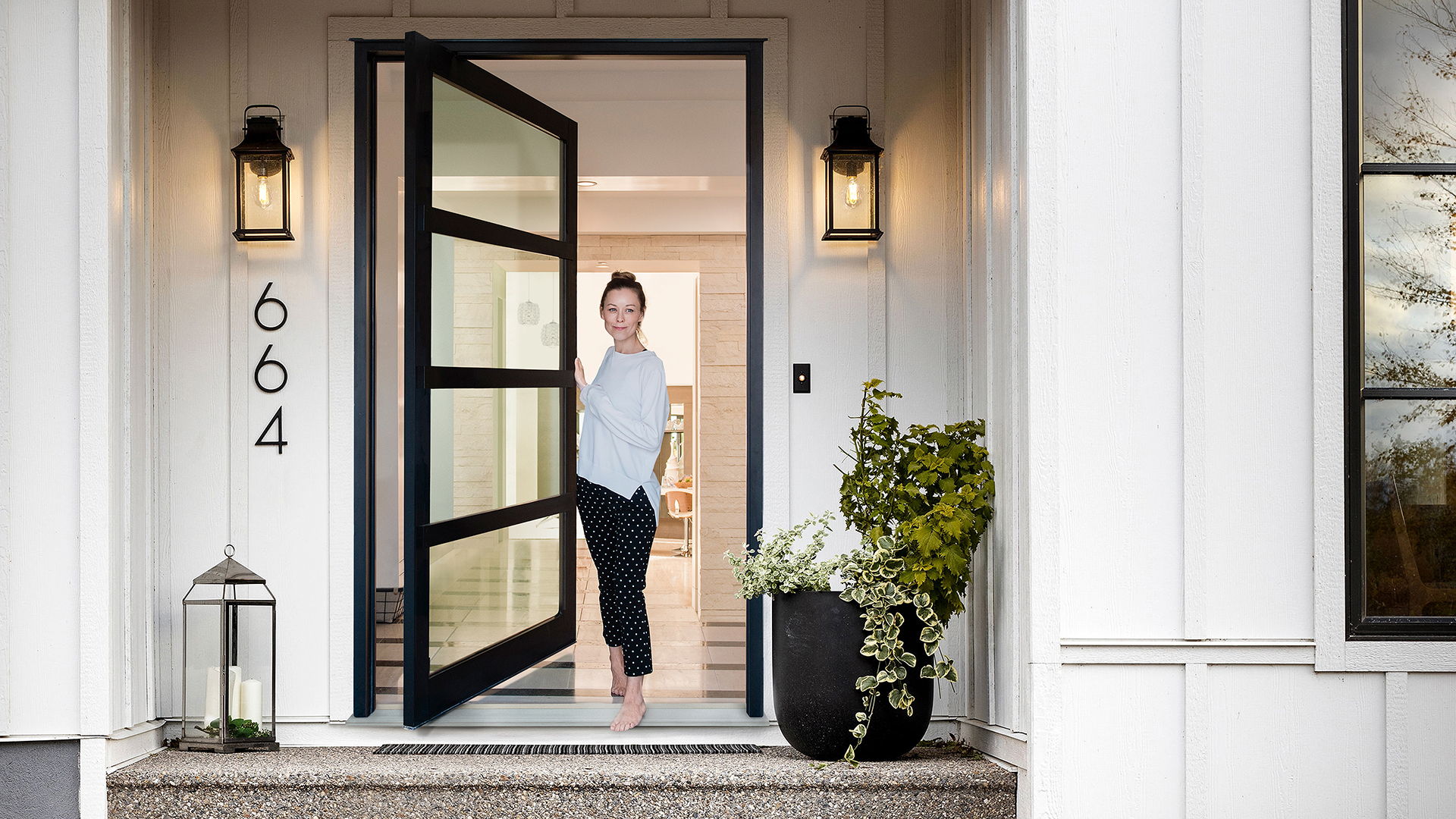 Woman opening her Lux Pivot doorway